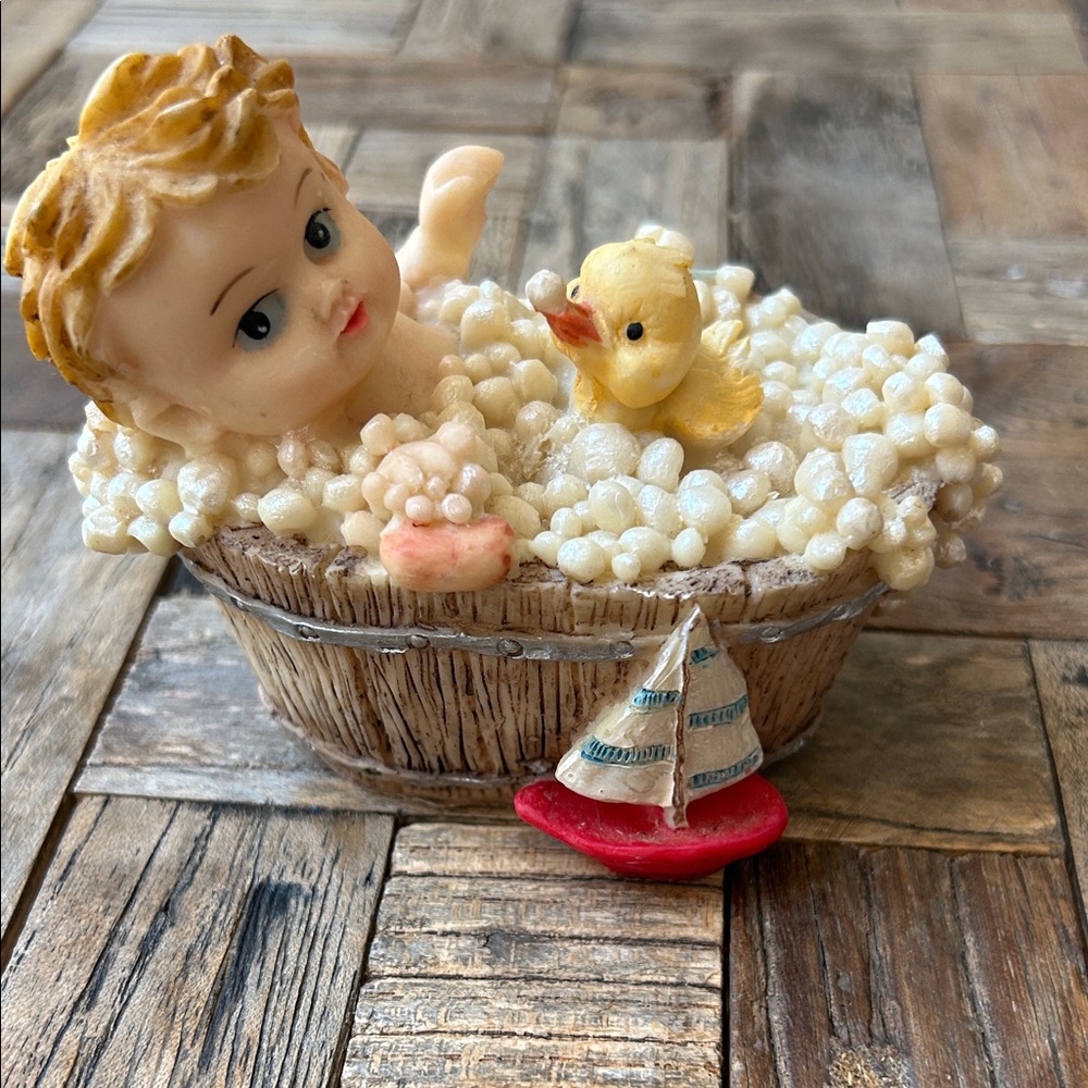Baby figurine in bathtub with bubbles
